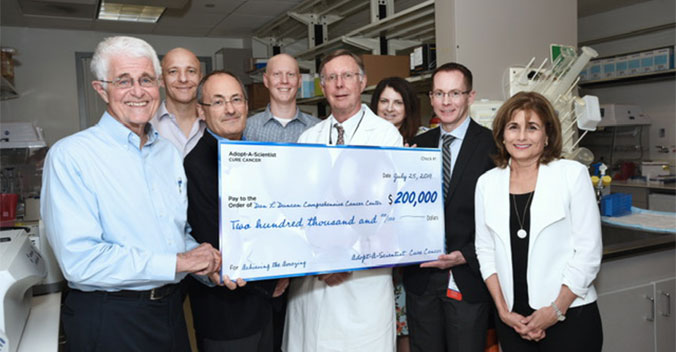 Adopt-A-Scientist – Cure Cancer check presentation to Baylor College of Medicine for ultra-sensitive, non-invasive molecular assays for rapid disease monitoring and response to therapy research on July 25, 2019. Dewey Stringer, Dr. Eric Jonasch, Dr. Matthew Ellis, Bryson Goeres, Dr. C. Kent Osborne, Elise Neal, Dr. George Miles, and Katherine Pulse